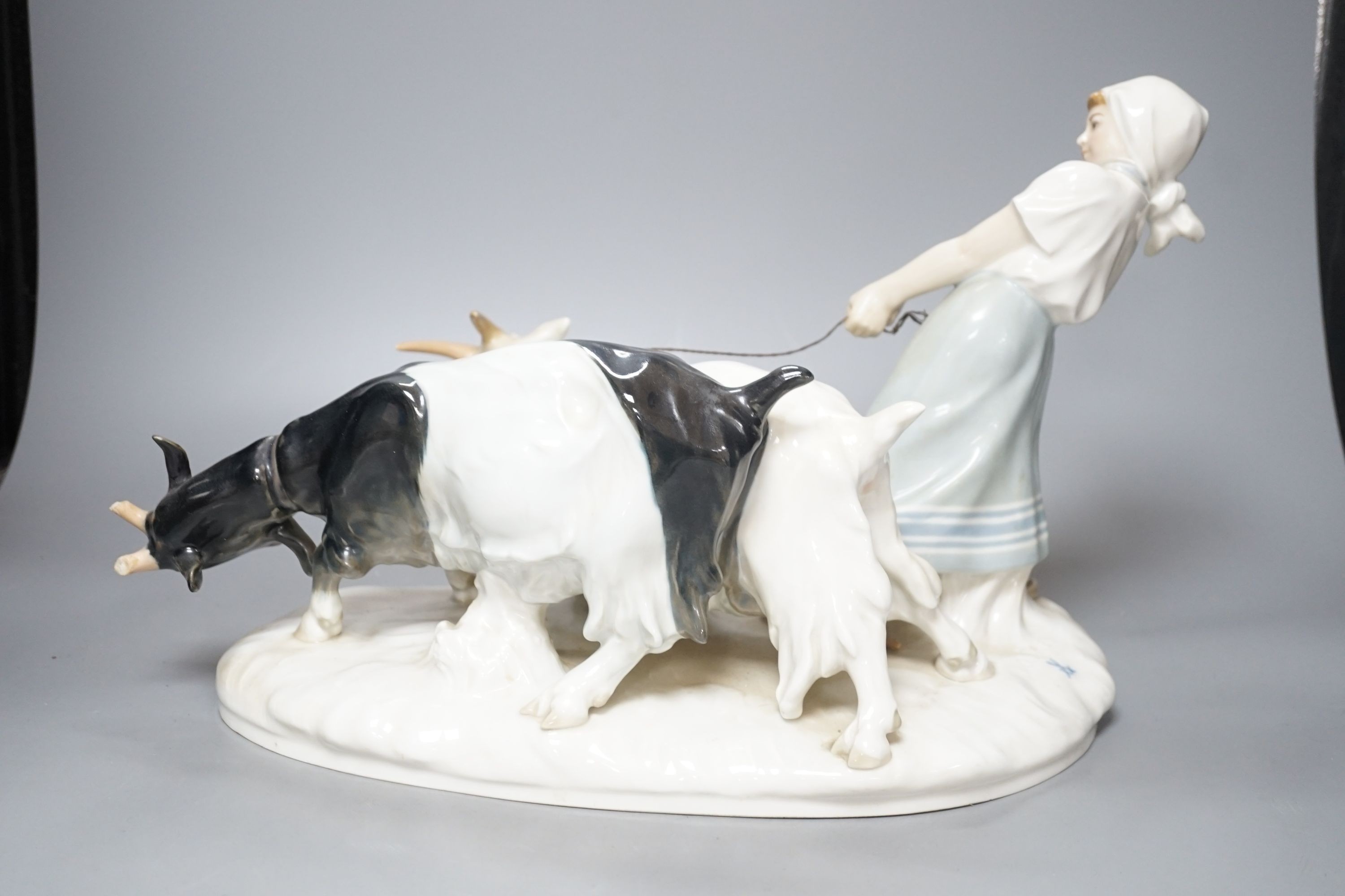 A Meissen figural group of young female rearing goats, modelled by Otto Piltz, 41cm long